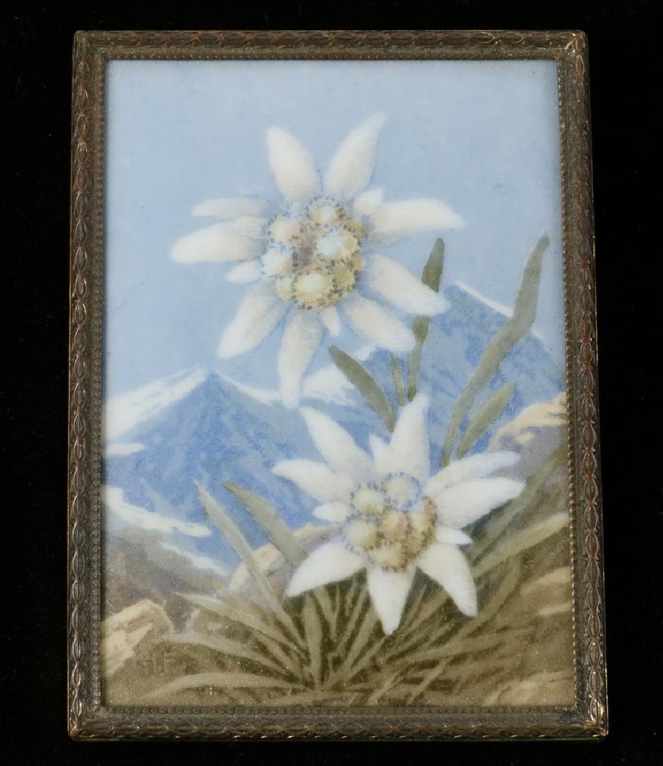 ENAMEL ON PORCELAIN MINIATURE: Two Edelweiss Blossoms in Rocky Crag with snow covered Alps in background, initialed 'HP' lower left, '98' impressed in back, ca. 1930, in embossed brass frame with Munich label for F. Mayer verso, pr