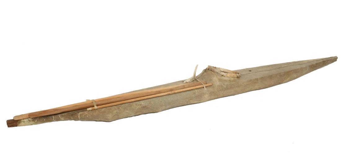 EARLY INUIT MODEL KAYAK: Sealskin over Wood, with wooden accoutrements, bone grip, circa 1940, 50" long, 5" beam. Very good condition.