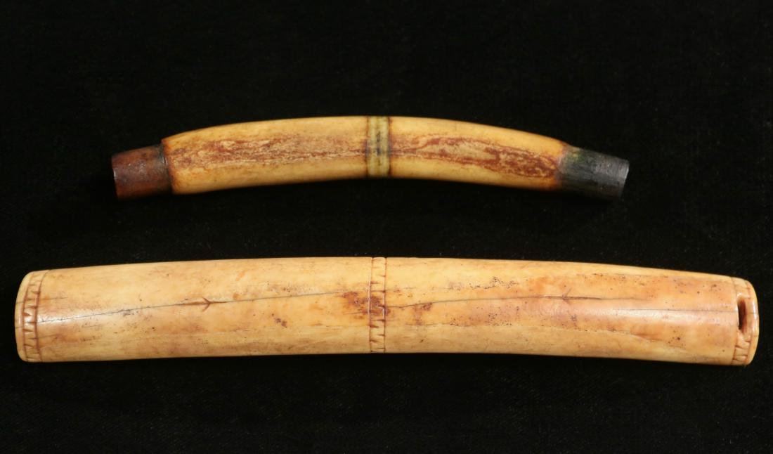 (2) INUIT BAG HANDLES: Both late 19th c., one from a hollowed bear claw, with copper tube ends, green stained center engraved stripe, 4 3/4" long; the second of fossilized mammoth tusk, with slotted ends, three engraved ban