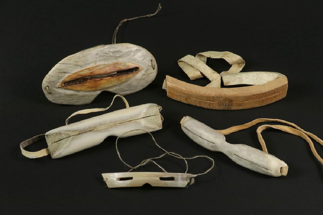 (5) INUIT SNOW GOGGLES: All 20th c., in various material including bone, antler, wood, with leather straps or twine, 3 3/4" to 6". Good condition.