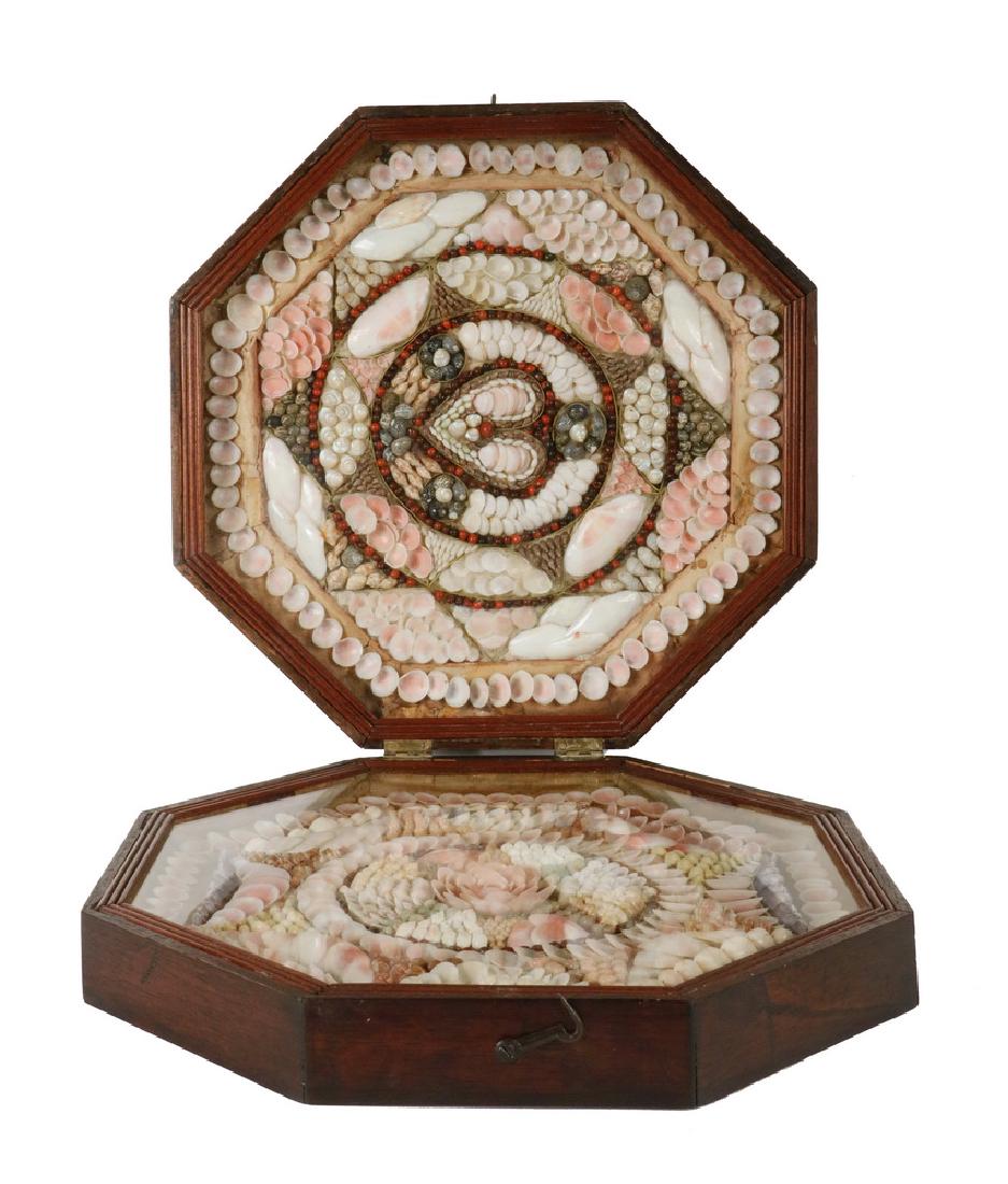 SAILOR'S VALENTINE: Large 19th c. Folk Art Sailor's Valentine in an octagonal hinged case of walnut stained oak, the delicate valentine composed of tiny shells in heart and floral form motifs, under glass, case (closed)