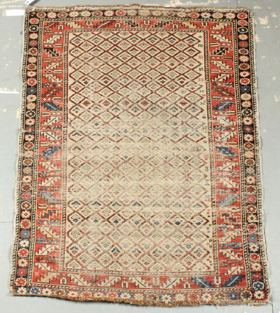 KUBA RUG - 3'-2" x 4'-3": Northeast Caucasus, late 19th c., diamond lattice with small single diamonds and chevron inset, in Persian blue, red, gold, brown on the tan field, red 'wine cup' and serrated leaf border. Large areas