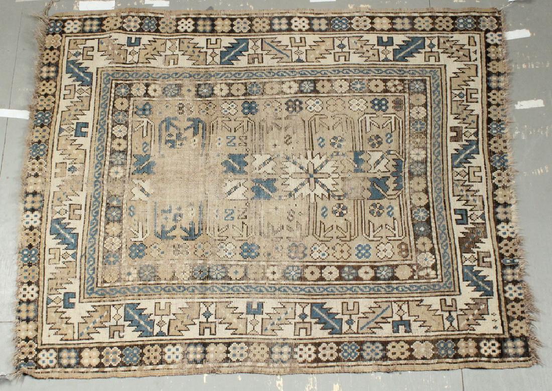 KAZAK RUG - 3'-5" x 4'-3": Southwest Caucasus, late 19th c., overall quatrefoil design with a cross, leaves, rosettes and arrows in Persian blue, gold, brown and ivory on the tan field, beige, serrated leaf and 'wine cup' borde