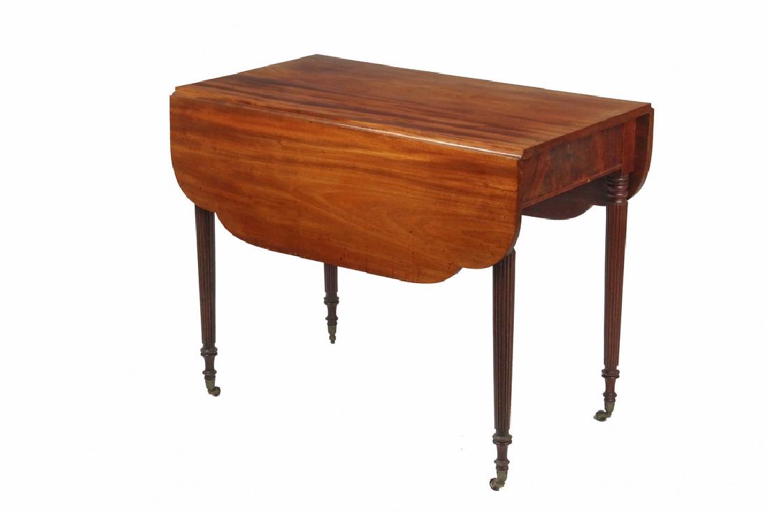 SHERATON DROP LEAF TABLE: Period Figured Mahogany Table with shaped leaves, tapered reeded legs with brass ferrule casters, concealed drawer in one end, 28 1/2" tall, 35 1/4 x 2 1/2" with 11 3/4" leaves. Sun faded top.