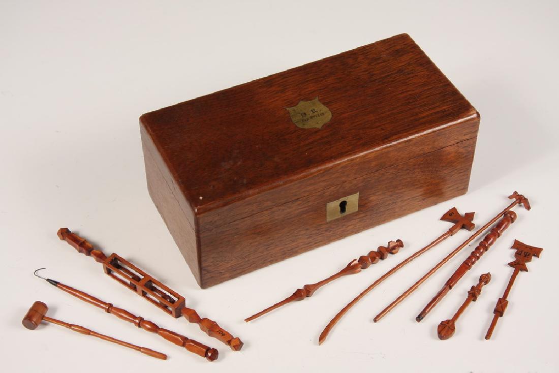 HAND CARVED PICKUP STICKS IN BOX: Mahogany Box with Engraved Shield reading 'D.R., Feb 3rd, 1863', containing (52) Hand Carved Wooden Pickup Sticks, in the form of fraternal staffs and symbols, some with inked Greek letters, all with 
