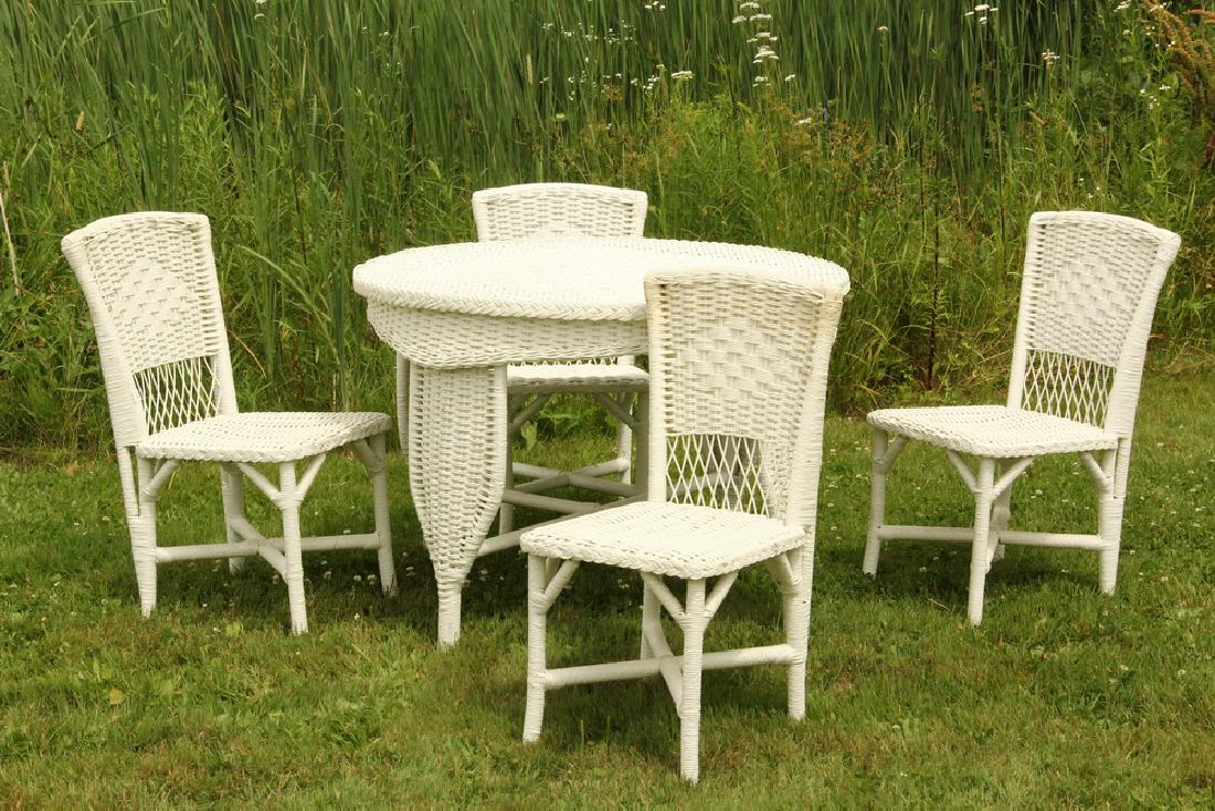 WICKER TABLE AND (4) CHAIRS: Vintage 1920s Bar Harbor Wicker in gloss white paint. The round table is 30 1/4" tall, 42 1/4" diam.; the simple chairs have 34 1/2" backs, 17 1/2" x 21". Soiled. Overall good condition.
