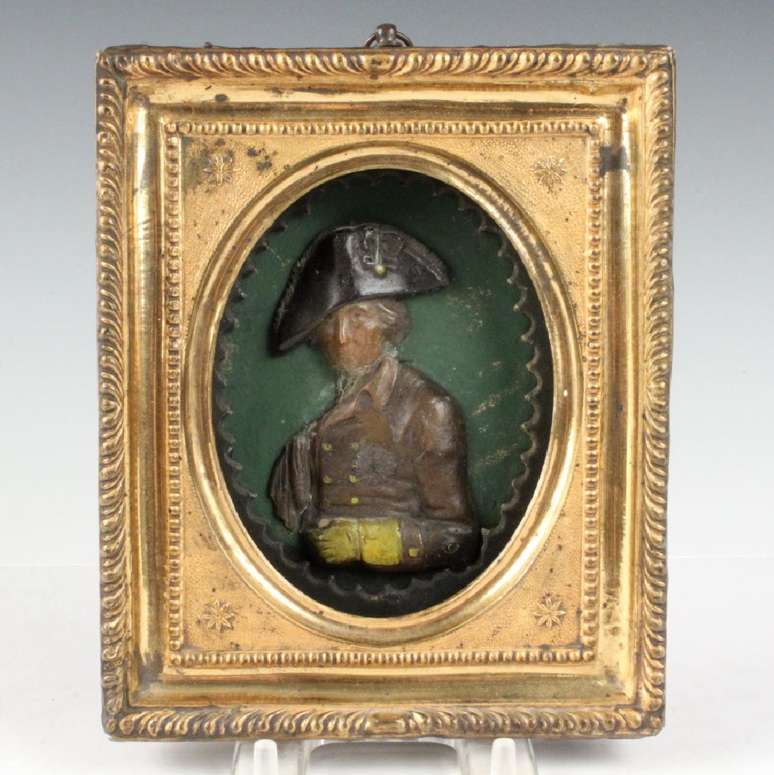 VINTAGE WAX PORTRAIT OF NELSON: Royal Navy Hero Admiral Lord Nelson, (1758-1805), an early 19th c. Commemorative Portrait in high relief wax with polychrome finish, possibly sailor-made, in the original pressed brass frame and shado