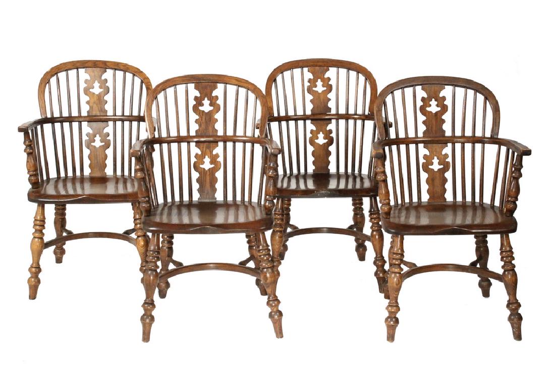 (4) ENGLISH TAVERN ARMCHAIRS: Dated 1952 Conant Ball Solid Yew and Elm Windsor Plank Bottom Armchairs, with continuous arm, spindle and splat back, bodged seat, splayed ring and urn turned legs, with u-shaped 'crinoline' stretcher