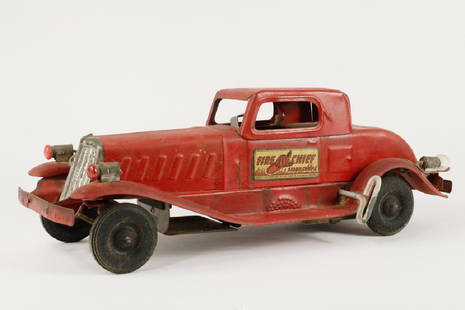 GIRARD FIRE CHIEF SIREN COUPE TOY CAR: Vintage Pressed Steel Wind Up Clockwork Fire Chief Car by Girard Model Works, red painted with D-size battery operated lights, decals on door sides, 5 1/4" high, 13 3/4" x 5 1/8". Wind up mechanism no