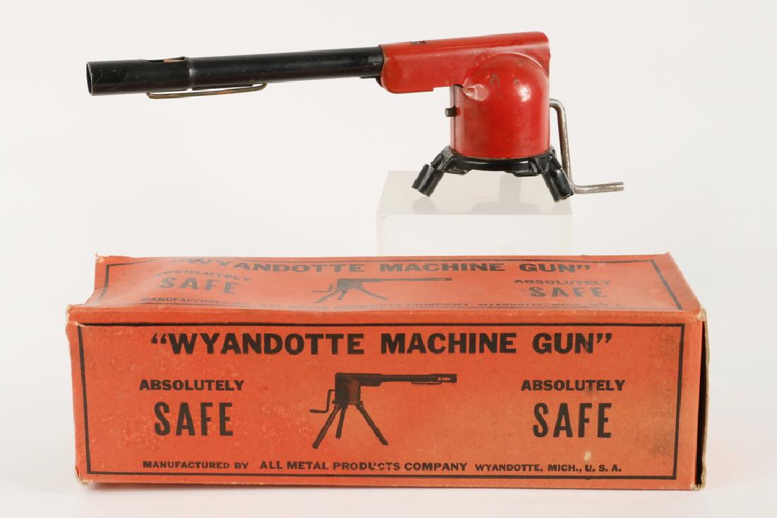 WYANDOTTE MACHINE GUN TOY WITH BOX: Painted Pressed Stell Toy Machine Gun by Wyandotte (All Metal Products Co., Pittsburgh, PA), with original box, missing wooden legs, 11" long. Paint losses, not operating.