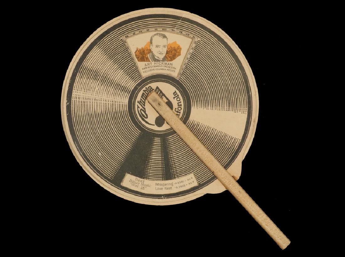RARE COLUMBIA ADVERTISEMENT HAND FAN: Circa 1925 Columbia Grafonola Printed Hand Fan with spinning dial showing select singers and hit songs, the back in chromolithograph with young couples in a park, "Take Music on Your Vacation", stampe