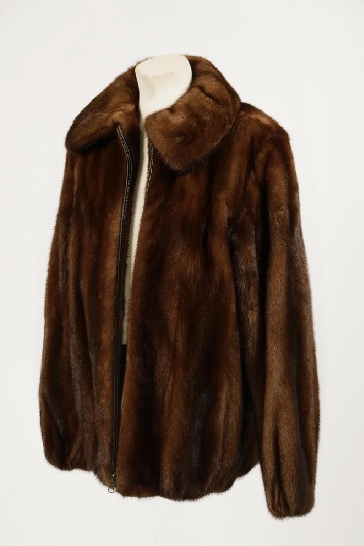 CHOCOLATE BROWN MINK JACKET: Chocolate Brown Female Skins Mink Jacket, hip length with zip front design, elasticized cuffs and bottom hem, wing collar, two front slash pockets, dark brown satin lining, no maker's label, 27" long,