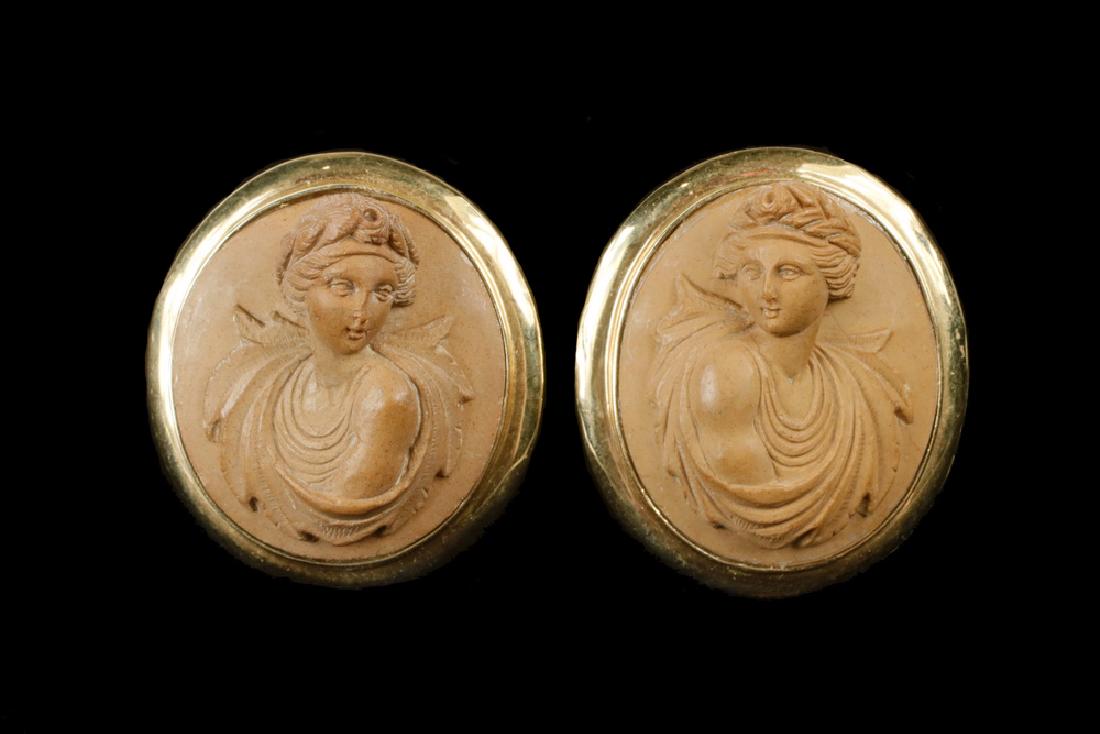 EARRINGS: Pair of Oval Lava Stone Cameo Earrings depicting full bust, raised female design with contemporary 14K yellow gold omega backs. Circa 1860. 1 1/4" long, 1" wide. Provenance: From the estate of Arthur