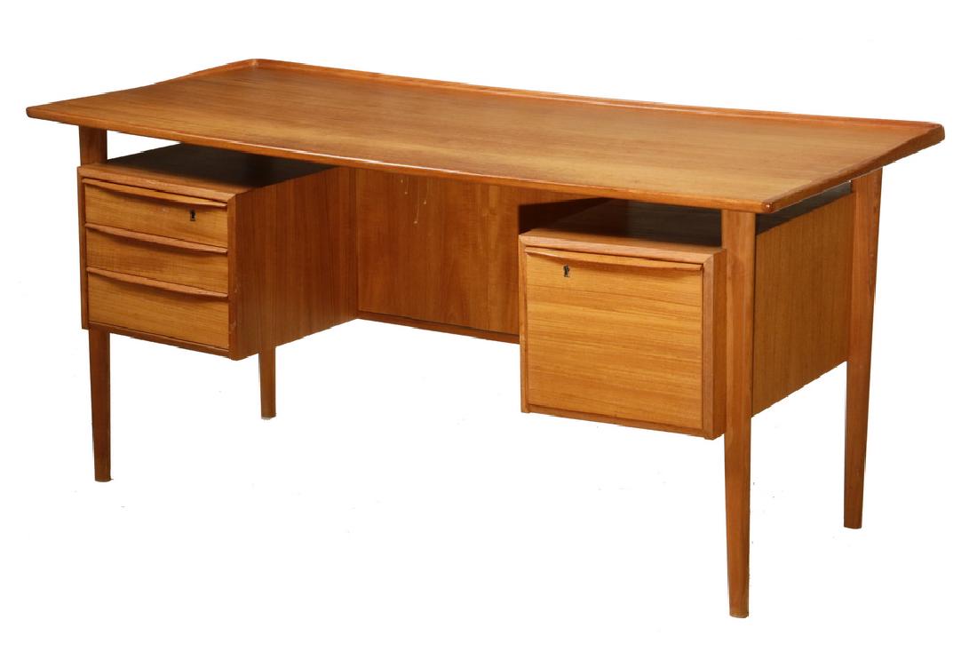DANISH MODERN DESK BY GUNNI OMANN: Free-Standing Desk with Floating Top (Model 75), in teak, for Omann Jun Mobelfabrik, circa 1955-65, Denmark, having a shallow gallery, two underhung inset cabinets containing three drawers and a file