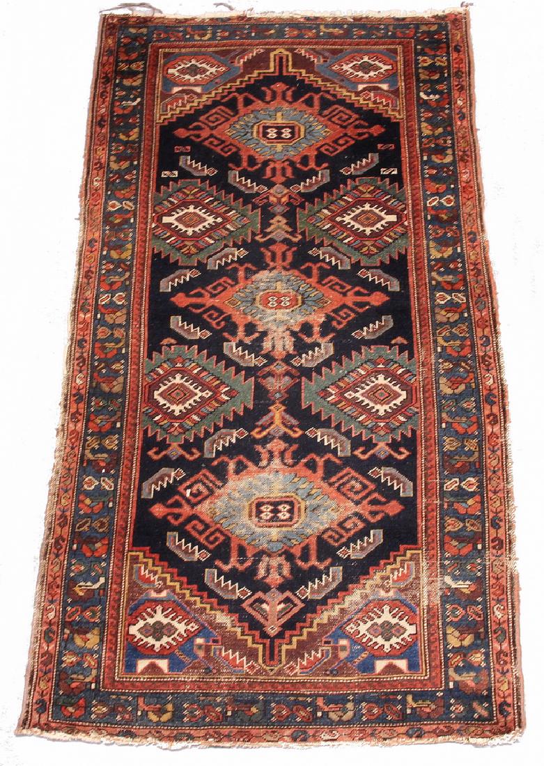 HAMADAN RUG - 3'-4" x 6'-2": Northwest Persia, second quarter 20th c., three hooked diamond medallions in rust red, blue-green and midnight blue flanked by concentric diamond motifs, on a midnight blue field, Persian blue rosette
