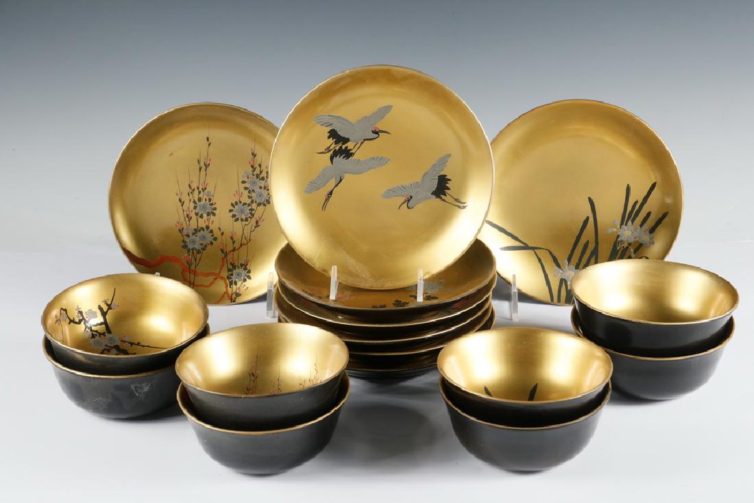 RICE SET: Sixteen piece hand painted oriental rice set, eight matching bowls with underplate, each set with different scenes, gold interior with black laquered exterior, bowls 2" x 4 3/4", plates 6 3/4" diam. G