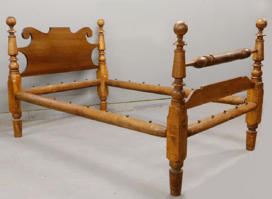 TIGER MAPLE CANNONBALL BED: Circa 1830 Maine Country Rope Bed in solid tiger maple, with cannonball finials, boldly turned posts, ram's horn panel headboard and quilt bar footboard, the rails having wood screw ends, in pumpkin p