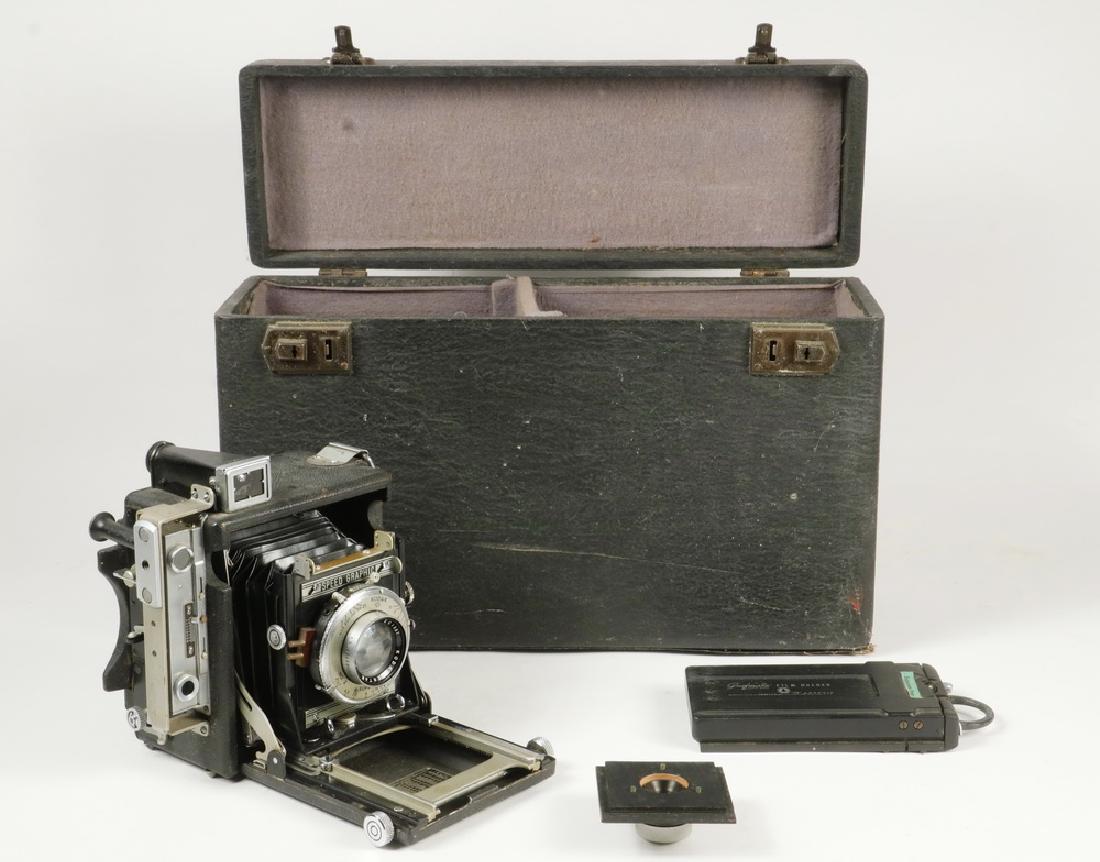 SCARCE SPEED GRAPHIC CAMERA IN CASE: Baby Graflex Speed Graphic '23' with an integrated range finder and focal plane shutter, (17) Film Packs, Kodak No. 2 Supermatic lens and a Zeiss Jena 1:9 .5cm lens nr 915175, mounted on plate. A nice