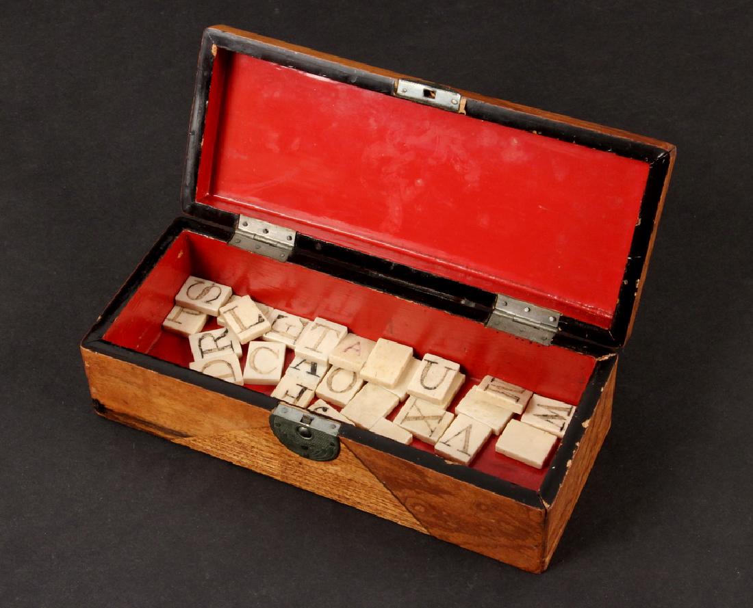 SAILOR CARVED BOXED SET OF WHALEBONE ALPHABET TILES: Set of (26) 19th c. Carved Whalebone Alphabet Tiles, each with a different scrimshaw alphabet letter, in a newer Chinese inlaid rectangular wooden box with red and black lacquered interior, each tile: