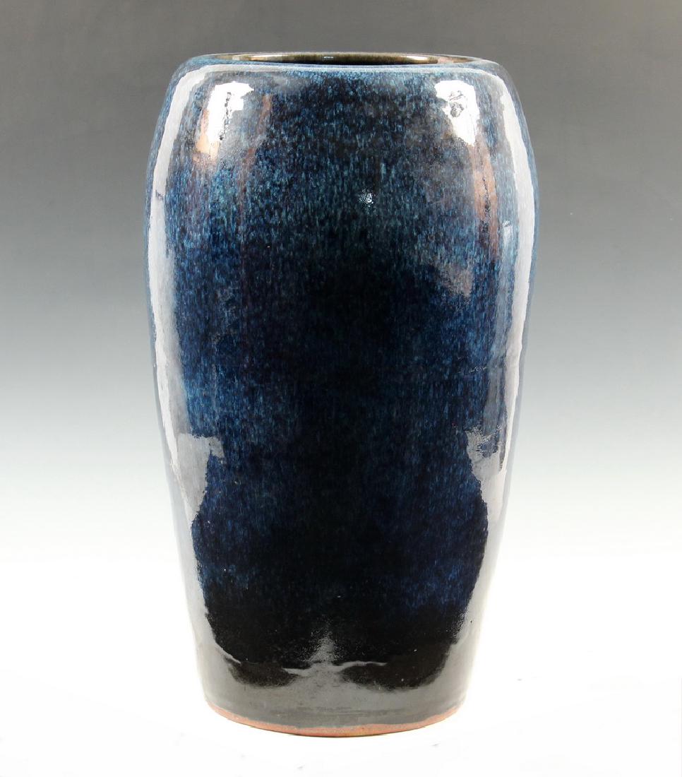 LARGE ARTS & CRAFTS BLUE GLAZED FLOOR URN: Large Stoneware Floor Vase, early 20th c., with blue flambe glaze, illegible stamped ink maker's mark on the underside, 25" high, 15" diam. Good condition.