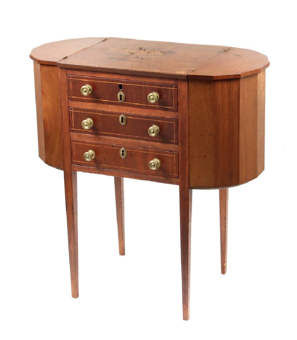 MARTHA WASHINGTON SEWING STAND: Early 20th c. Custom Sewing Stand in the Traditional Heppplewhite pattern, having seven-sided cabinet ends with hinged tops, three shallow drawers with pressed brass knobs, oval lock escutheons (locks