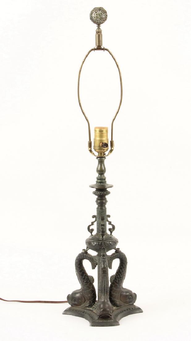 NEO-CLASSICAL DESK LAMP BASE: Bronzed Spelter Lamp Base featuring Three Dolphins in the Italian style, circa 1920s, supporting a single electric socket, shade harp, no shade, piercework finial, 27" x 7". Good condition, new socket