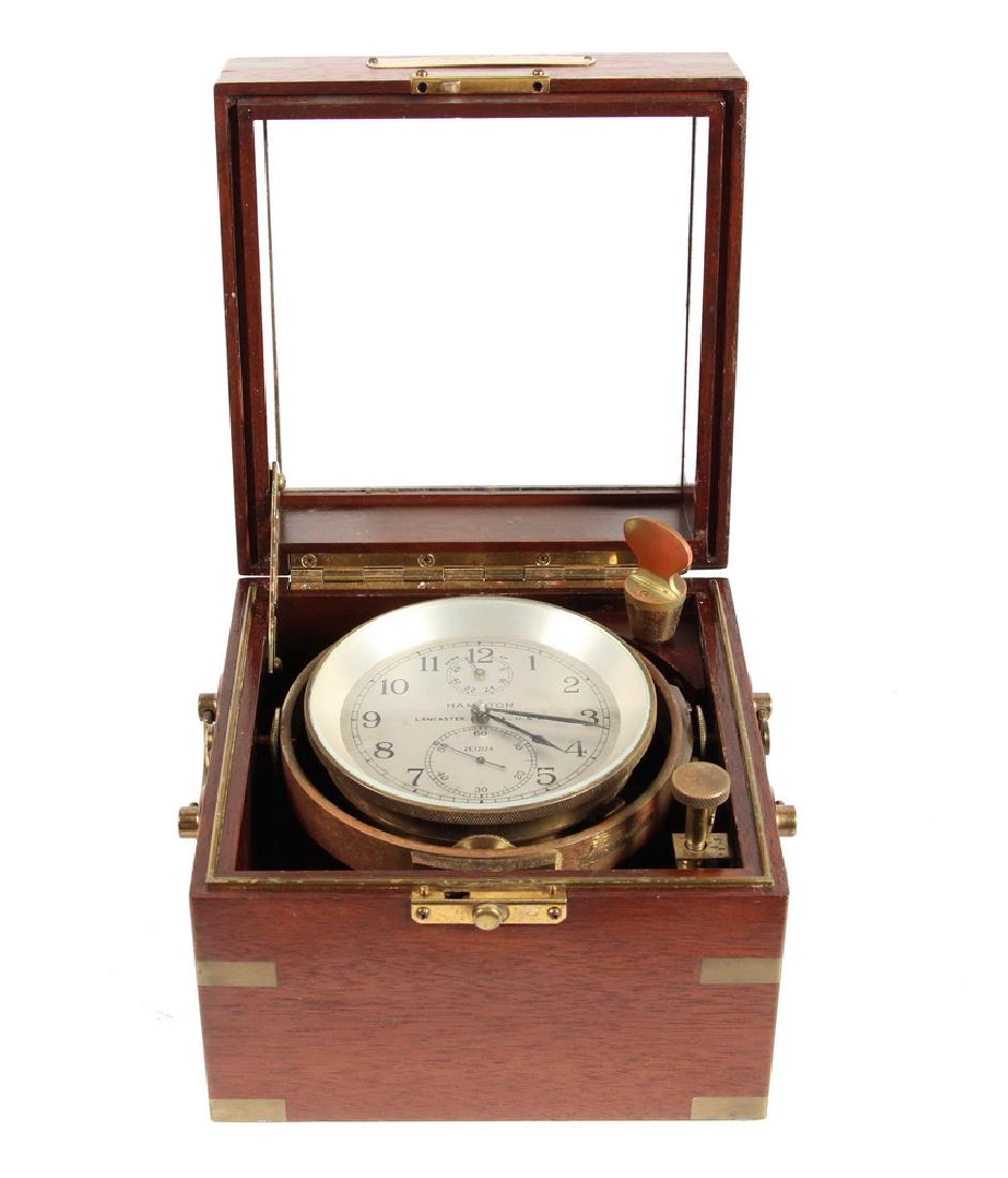 WWII HAMILTON WATCH CO. SHIP'S CHRONOMETER IN BRASS: Hamilton Model 21 Chronometer from the Freighter S/S "Reuben Tipton", s/n 2E12126, unmarked but with papers including a Chronometer Rate Certificate from Baker, Lyman & Co. in New Orleans, dated March