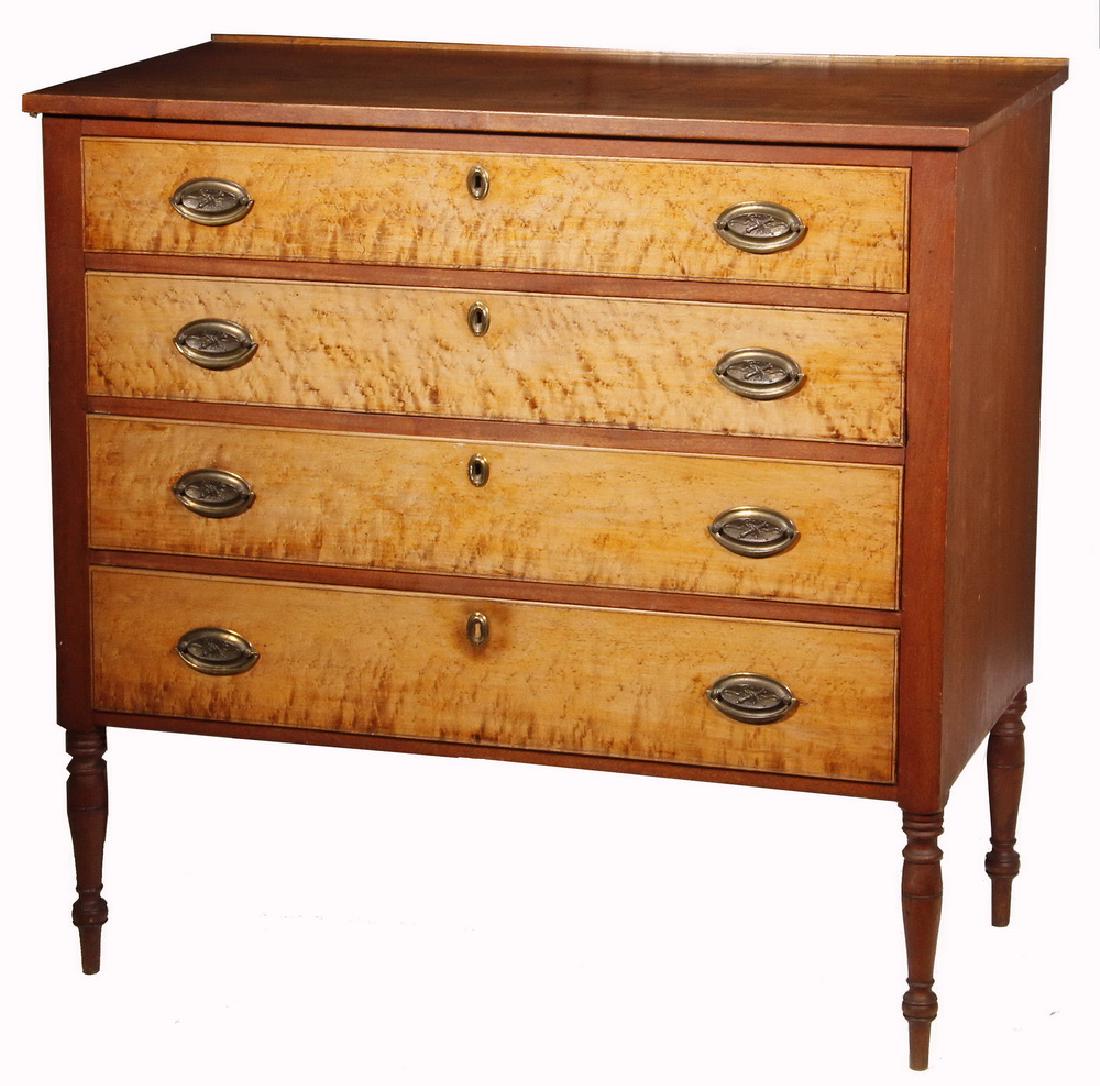 CIRCA 1800 FOUR-DRAWER STATE OF MAINE CHEST: Mahogany Chest with single plank overhanging top having small backstop, four scored-edge graduated drawers with bird's-eye maple fronts, later oval brasses having a martial theme, locks (no key), pine