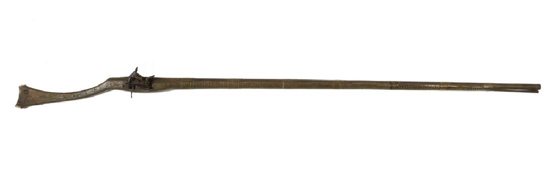 19TH C. TURKISH OTTOMAN FLINTLOCK GUN: Antique Turkish Ottoman Miquelet Lock Musket with fishtail stock, with a 52" engraved .62 cal. round barrel, tooled brass straps and wrap to stock, original iron ramrod, 67 1/2" long overall, missing 