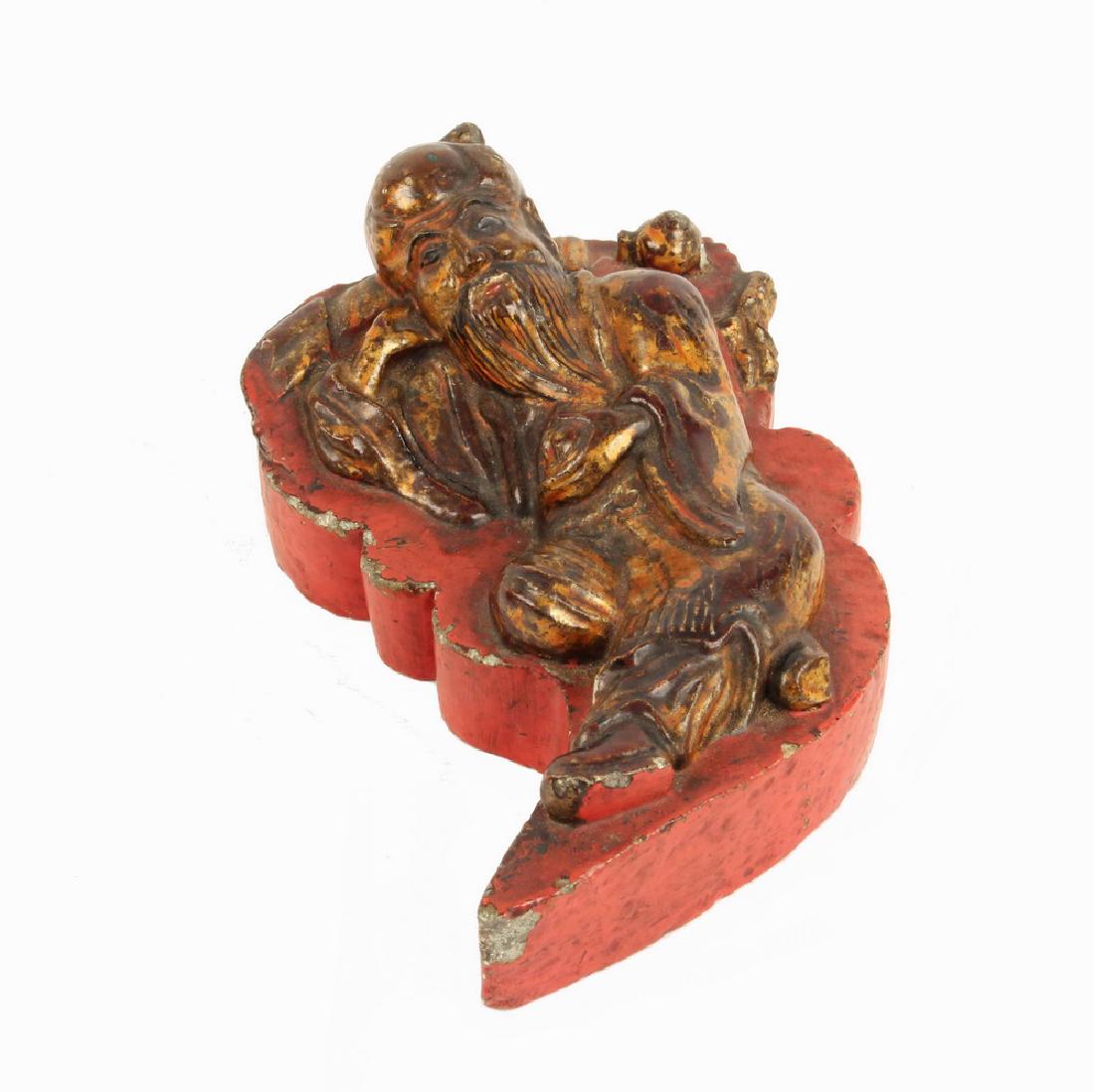 CHINESE CARVED SOAPSTONE FIGURE: Rare Chinese Carved and Lacquered Reclining Confucius Figure, 18th-19th c., gilded figure on red lacquered integral base, he is depicted holding a plum with a snail beside him, 3 3/8" high, 8 1/2" x 5