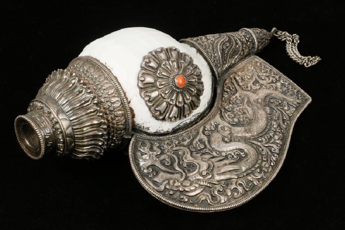 TIBETAN SHELL HORN: Tibetan Buddhist Ceremonial Horn, or 'rag gshog-ma', a musical instrument believed to banish evil spirits, 20th c., consisting of a polished left-handed sacred chank or 'divine conch' shell with silve