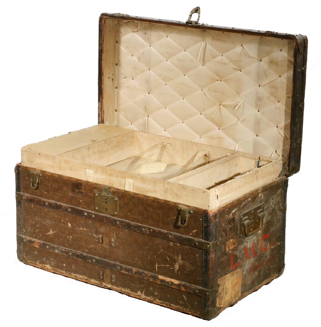 EARLY LOUIS VUITTON TRUNK: Louis Vuitton Steamer Trunk, c. 1900, with monogram canvas exterior and wood trim, two original interior lift out trays, one tray with lidded compartments on each side, original side handles marked Lo