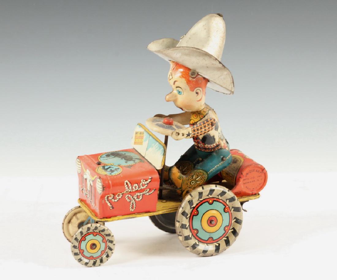 "RODEO JOE" TIN LITHO TOY: 1940s Tin Litho "Rodeo Joe" Wind Up Toy, by Unique Art Mfg. Co., Inc. (Newark, NJ), when wound the jeep moves backward and forward as Joe bounces in his seat, 9 1/4" high, 7" x 3 5/8". Clockwork mecha