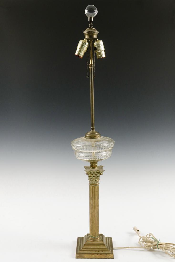 COLUMN FORM TABLE LAMP & PR ANDIRONS: Victorian Brass Column Form Kerosene Lamp, wired ca. 1930s as a table lamp, with clear cut glass font, Corinthian column stem and stepped square base, adjustable height, two-socket fixture with chain
