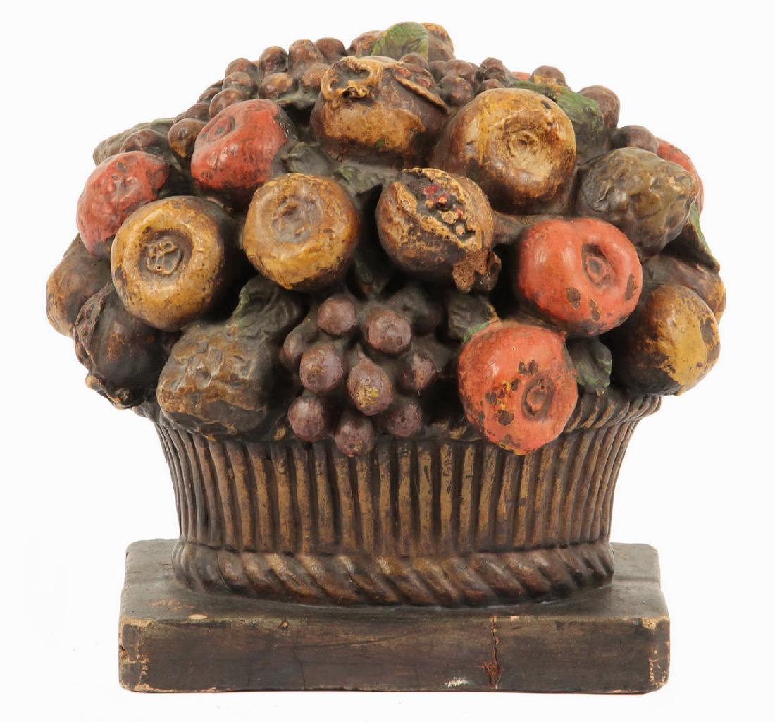 FOLK ART FRUIT BASKET: Early 20th c. Plaster Sculpture Depicting a Fruit Basket, polychrome painted in muted tones, 9 1/2" high, 9 1/4" x 8". Base corner chips, a few paint flakes.