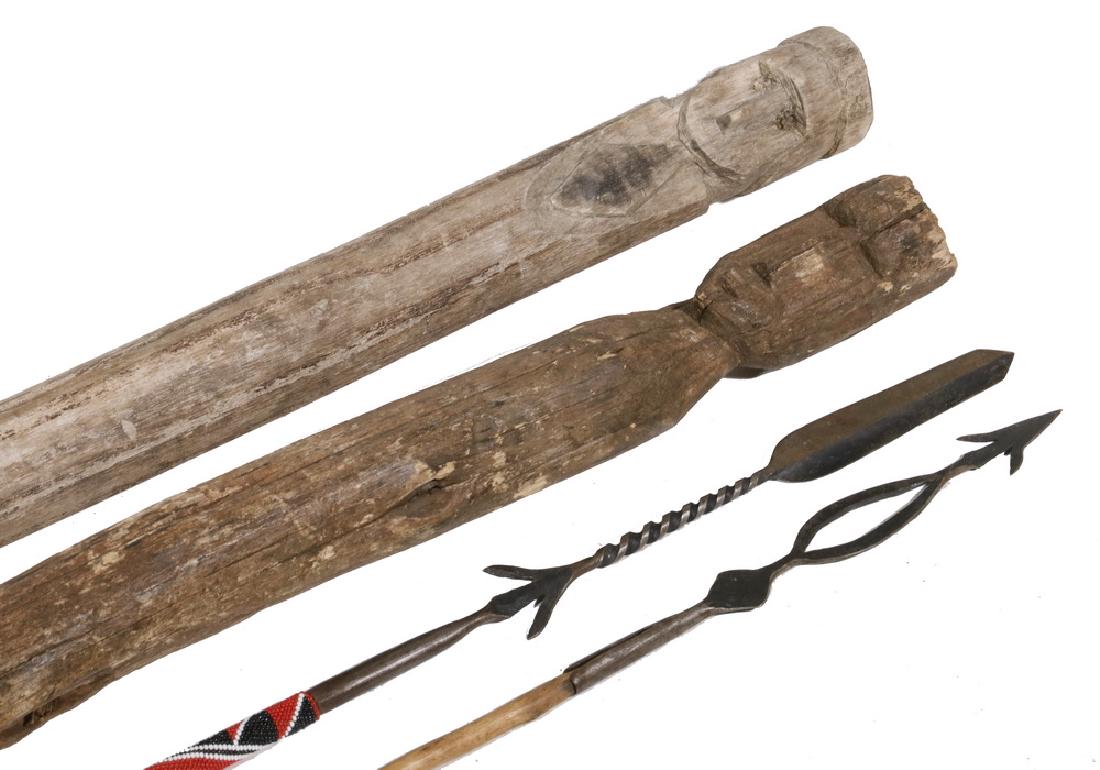 (4 PCS) AFRICANA: Including: (2) Dogon Guardian Posts, 37" to 48" & (2) Miniature Masaii Spears, one with beadwork, both with forged iron heads and lower tips in scale, 34" to 35". Weathering to posts, spears are in go