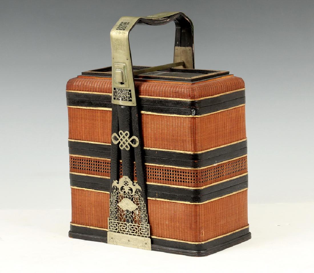 CHINESE WEDDING BASKET: Chinese Three-Tier Wedding Basket, comprised of wicker, wood and brass, 20th c., wood and reticulated brass handle with lock (missing key), 14" high, 10 1/4" x 5 3/4". Good condition.