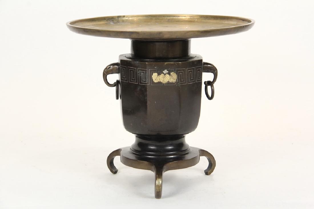 JAPANESE MIXED METAL BRAZIER: Meiji Bronze Brazier in the form of a Usubata Vase, with gold and silver inlay of the three hollyhock leaf mon for the Tokugawa Shogunate, 10 1/4" x 11 1/2" diam. Slight bend to the receiver rim, wear