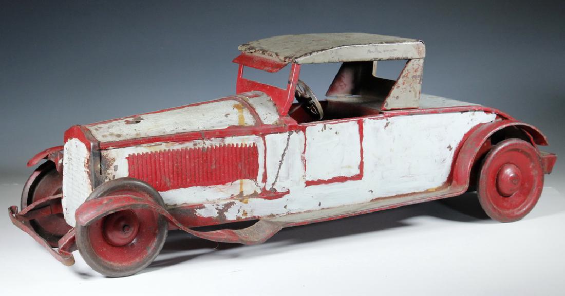TURNER TOYS PACKARD ROADSTER COUPE CAR: 1920s Pressed Steel Packard Roadster Coupe Toy Car by Turner Toys, with flywheel friction mechanism, front bumper, running boards, visor, steel disc wheels, steering wheel, areas of original red paint