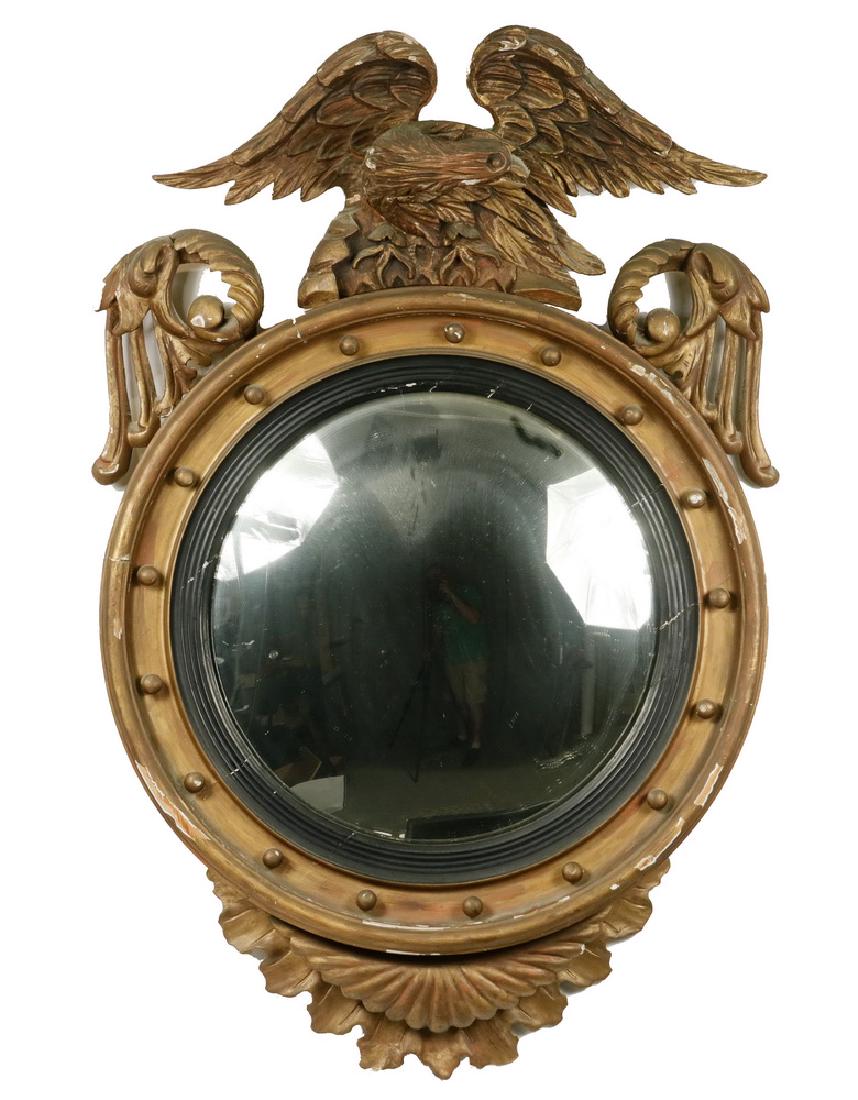 FEDERAL PERIOD BULL'S-EYE MIRROR: Circa 1810 Hand Carved Entry Mirror Frame in gold paint, featuring an eagle finial, flanked by scrolls and with pendant leaves below, (17) spheres in the deep cove round frame, 38" x 26". Some losses,