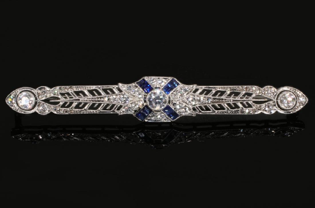 BROOCH: Edwardian Brooch in platinum, set with sapphires and diamonds, 2 1/2" long, 1/2" wide.