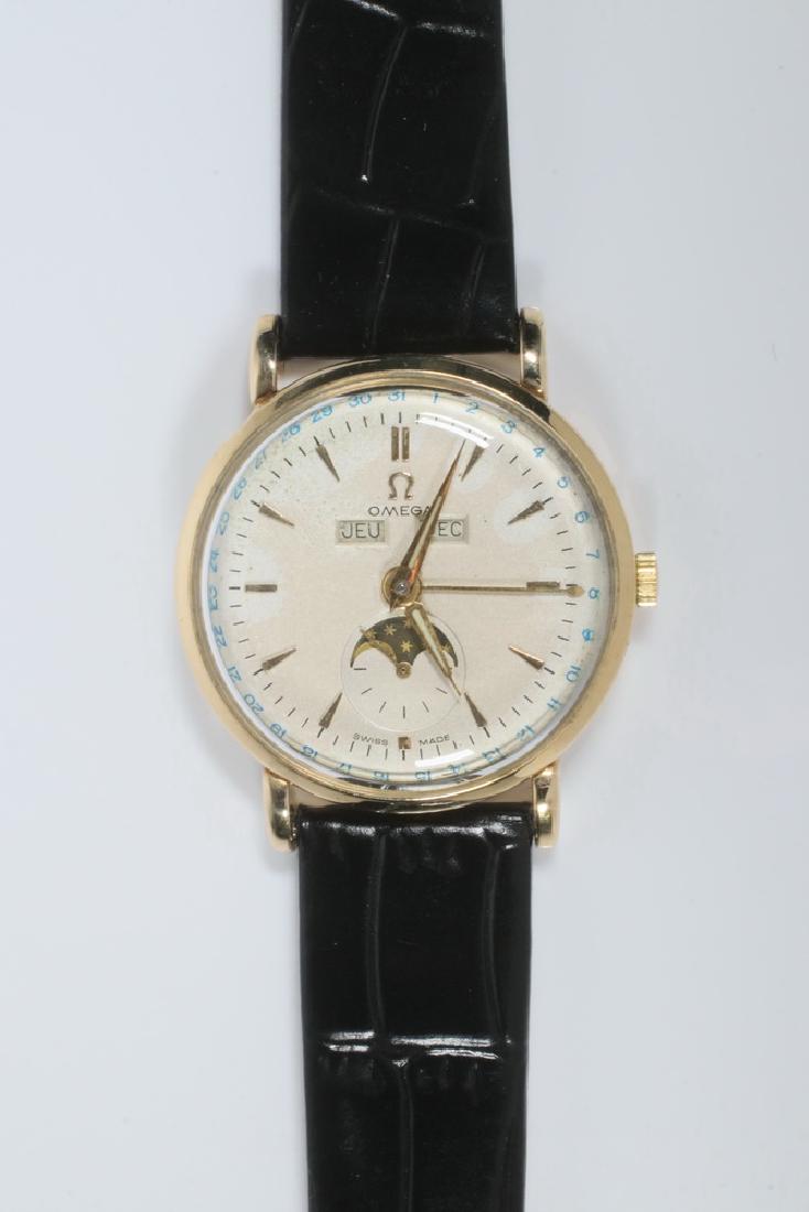 GENT'S WRISTWATCH: Vintage Omega Wristwatch with 18K yellow gold round head, day, date and moon phase, sweep hand, chronometer. Recently serviced, with new black leather band.