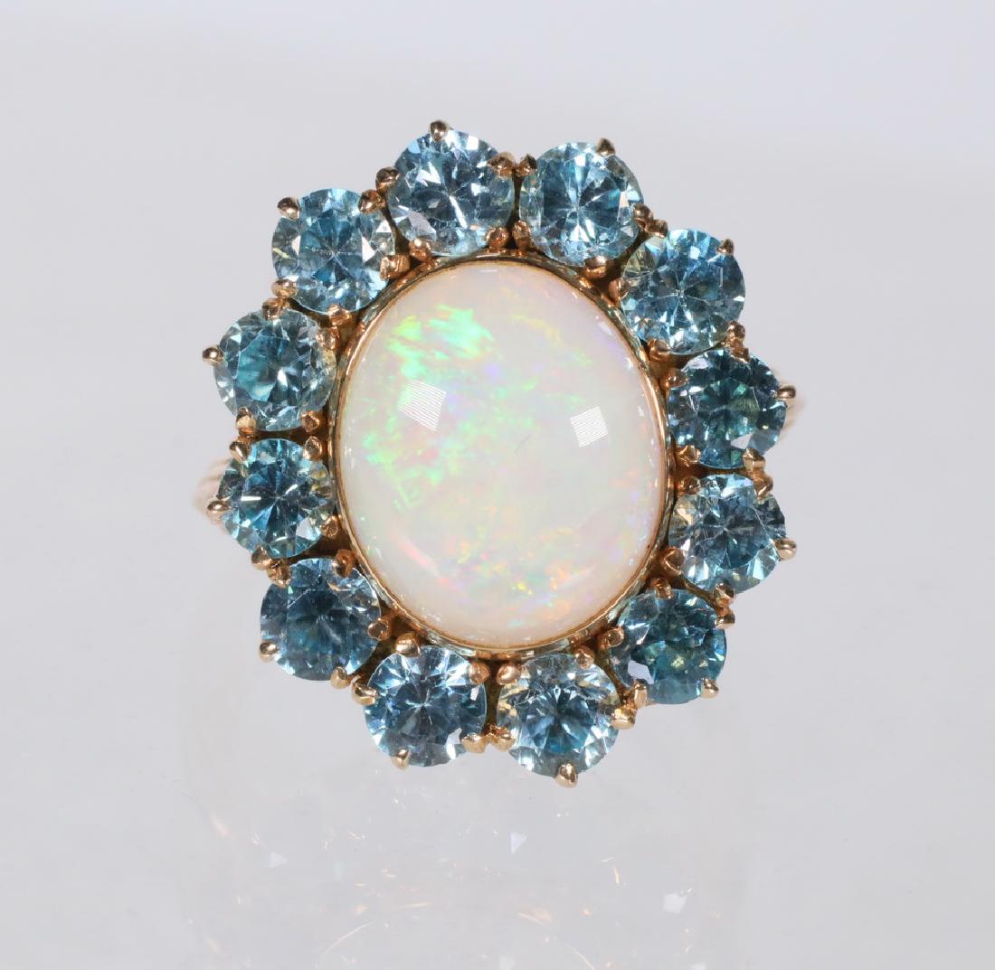LADY'S RING: Designer Ring in 14K yellow gold with opal center surrounded by (12) light blue zircons, size 6.