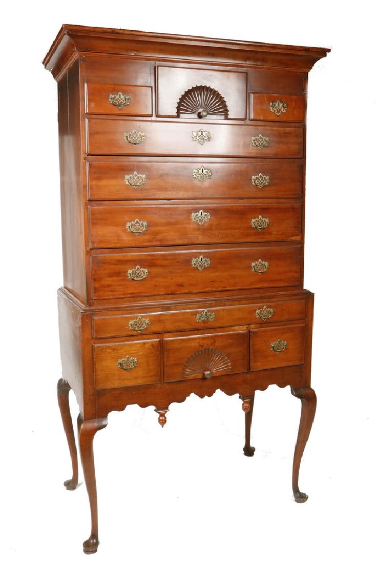 TWO-PART CHERRY HIGHBOY: 18th c. American Queen Anne Highboy with deep flat molded cornice, having a deep fan carved center drawer, flanked by two shallow drawers, with four graduated full-width drawers beneath, all with bead