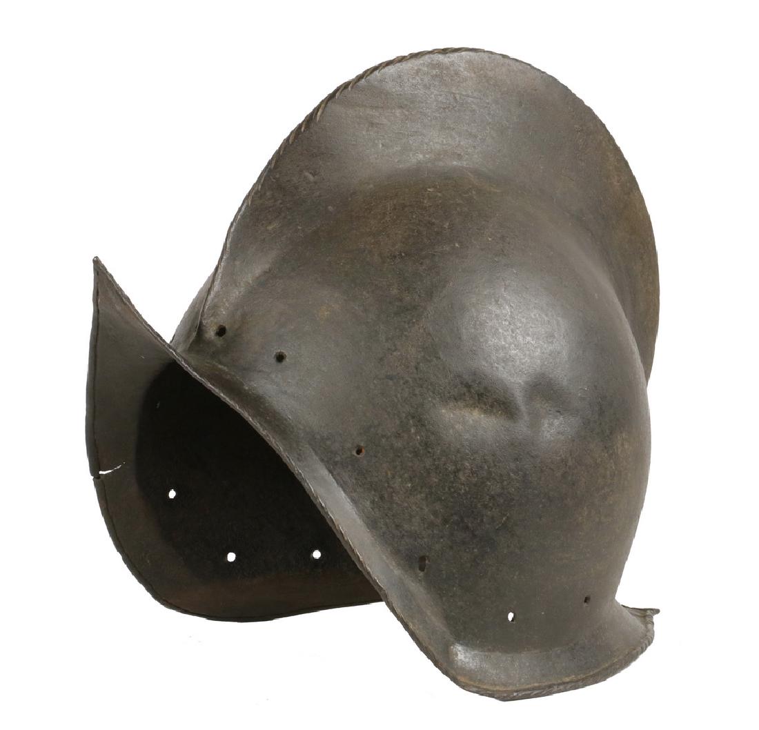 X-RARE 16TH - 17TH C. MORION HELMET: High Quality Late 16th to mid 17th century Morion Helmet, probably English, in hand-hammered steel with a roped edge to comb and brim, having holes from missing rosette rivets, 10 1/2" x 13 1/2" x 8 1