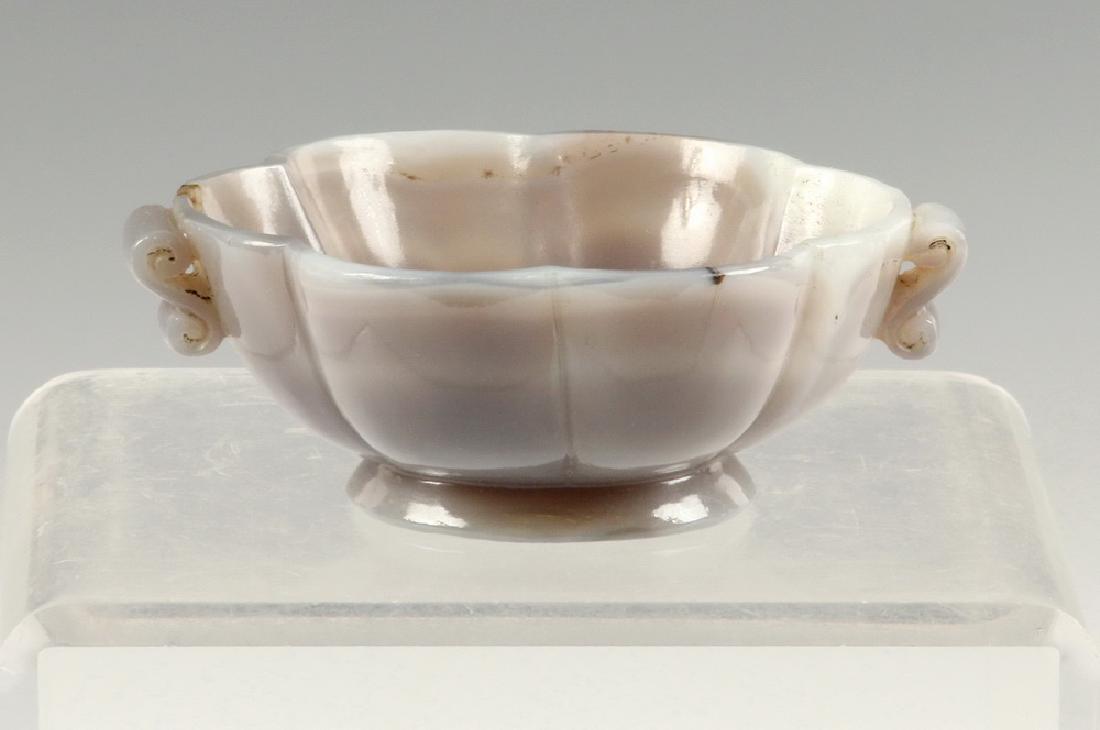 MELON SHAPED AGATE BOWL, MUGAL INDIA, 19TH C.: Indian Late Mughal Islamic Hand Carved Agate (Aqeeq) Bowl in misty grey color, polished, a melon form with double-scrolled handles, the shallow foot having a lotus blossom concealed on the underside. 