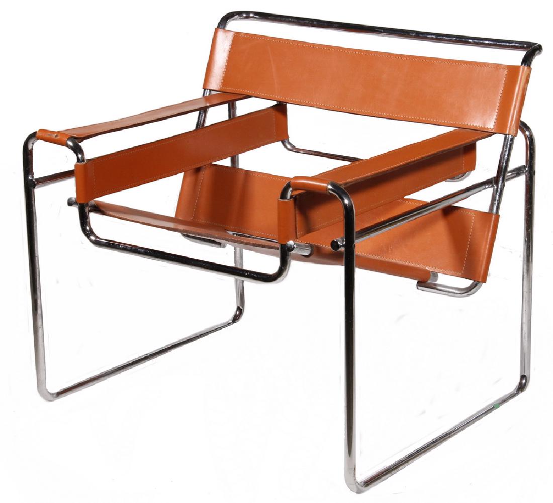 LEATHER AND CHROME WASSILY STYLE ARMCHAIR: Model B3, designed by Marcel Breuer in 1925-1926 while he was the head of the cabinet-making workshop at the Bauhaus, in Dessau, Germany. Unmarked, late 20th c., tubular chrome frame with orange leath