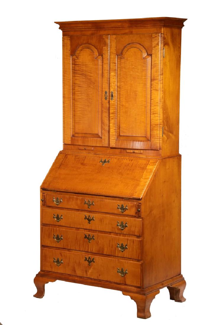 TWO-PART ELDRED WHEELER SECRETARY: Chippendale Style Tiger Maple Secretary with flat molded cornice, two arch molded rectangular doors over letter cubbies and shallow shelves, three shallow drawers at bottom, candle pulls just below th