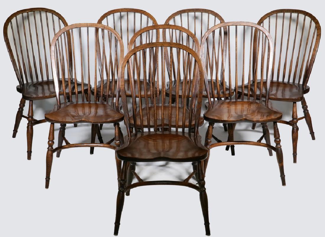 (8) ENGLISH WINDSOR STYLE CHAIRS: Set of (8) Bow Back Windsor Side Chairs, 20th c., each in elm wood with saddle form seat, turned legs, and crinoline stretcher base, 38" high, 21" x 19 1/2", seat: 18 1/4" high.