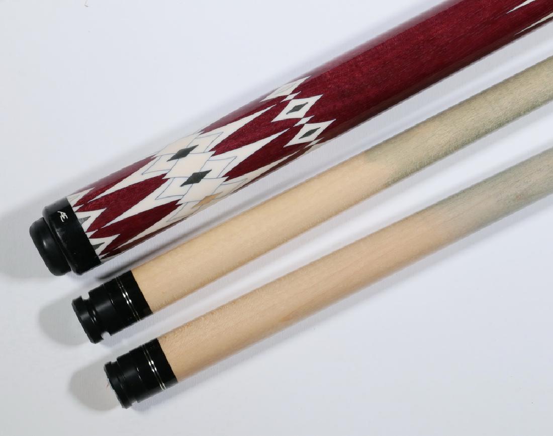 AE CUSTOM POOL CUE: AE Custom Made Pool Cue, in purpleheart intricately inlaid in an argyle pattern, with silver inlays, two shafts, marked 'AE' on butt cap, 58 1/2" long. Good condition.